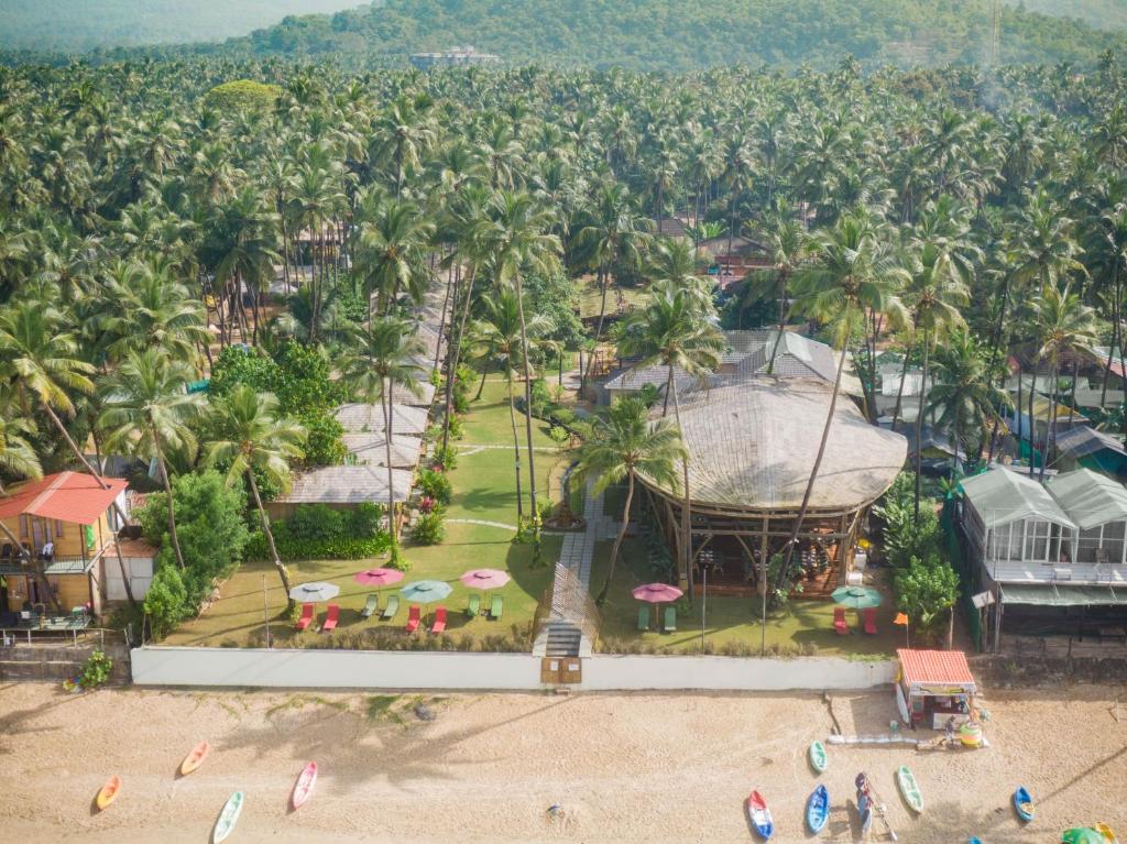 an aerial view of a resort with palm trees at The Wave , Palolem in Canacona