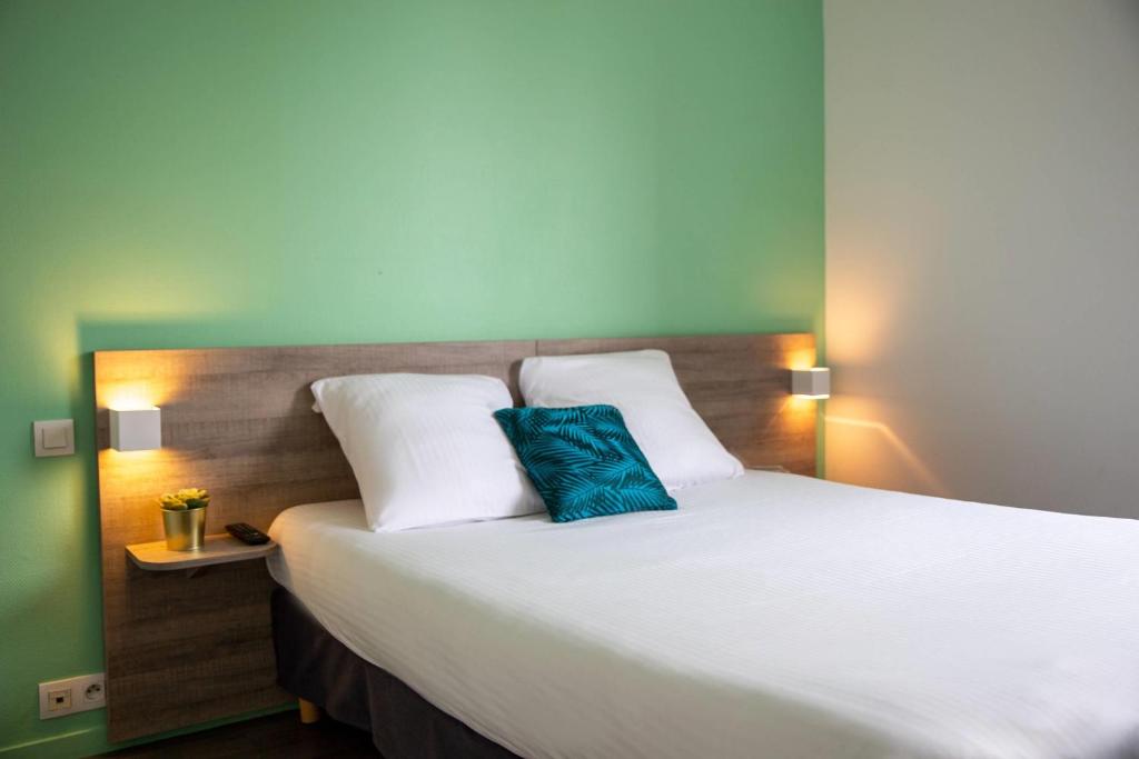 Ένα ή περισσότερα κρεβάτια σε δωμάτιο στο Comfort Aparthotel Toulouse Métropole