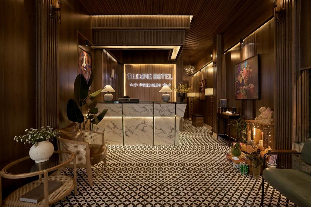 a living room with a lobby with a reception desk at The One Premium Hotel - 1 Minute to Ben Thanh Market in Ho Chi Minh City