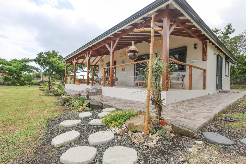 a house with a pathway leading to it at L Échappée Belle Havre de paix au cœur du verger in Le Moule