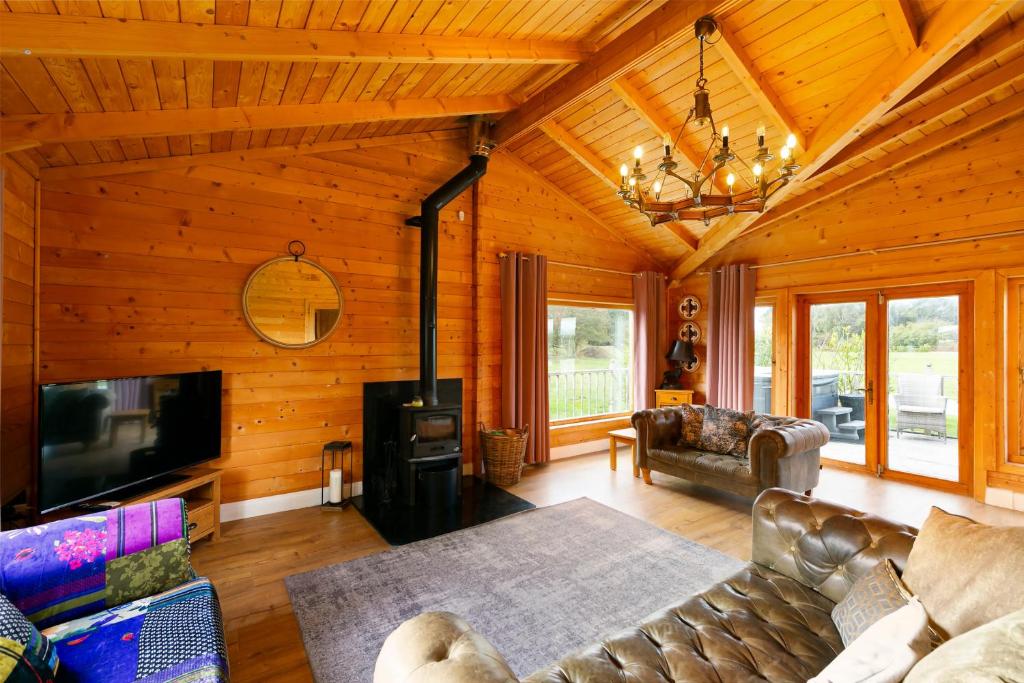 a living room with a couch and a tv at Beautiful 3-Bed Luxury Private Lodge in York in York