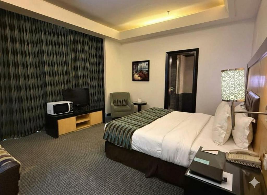 Ένα ή περισσότερα κρεβάτια σε δωμάτιο στο Dancenter Hotel Near Business Center Al Olaya