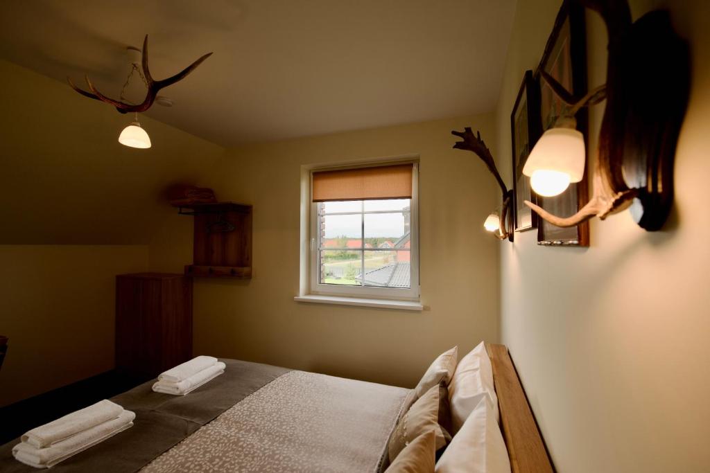 Postel nebo postele na pokoji v ubytování Šv Hubertas