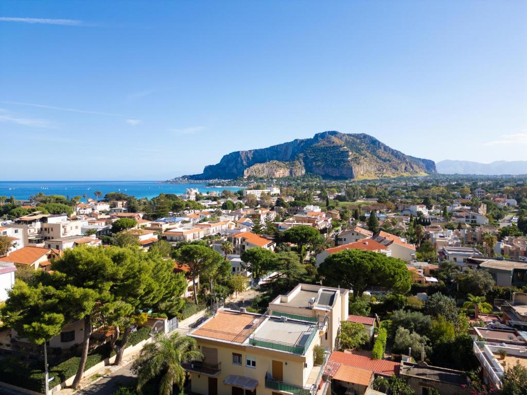 a view of a town with a mountain in the background at Solemar Sicilia - Villa Mariù in Palermo