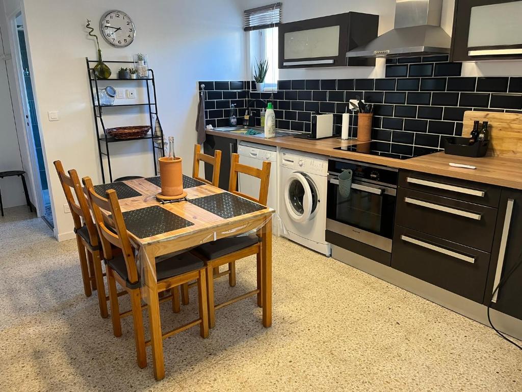 a kitchen with a table and chairs in a kitchen at New Appartement RDC de Villa 60 m2 proche plage in La Ciotat
