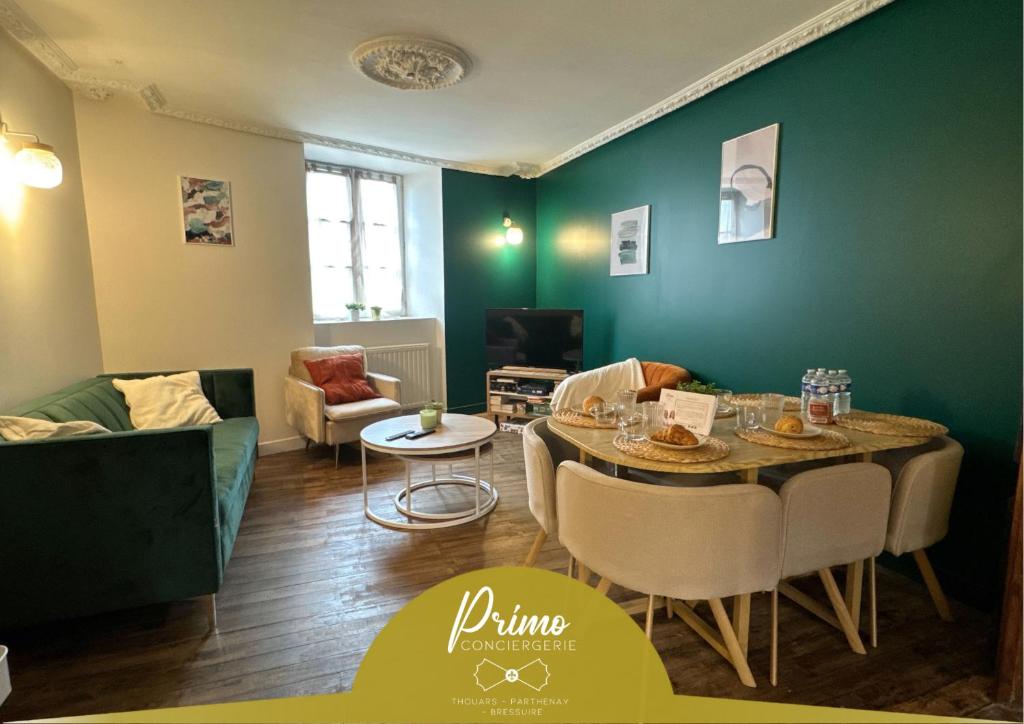 a living room with a table and chairs at La Maison D'Oscar in Parthenay