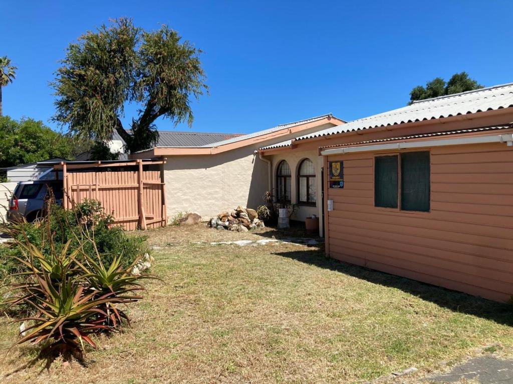 a house with a garage and a fence at Halibut Suite in Strand