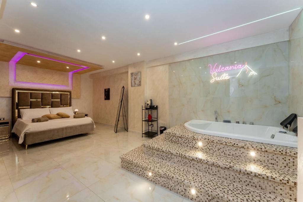 Un pat sau paturi într-o cameră la Vulcania SuiteA