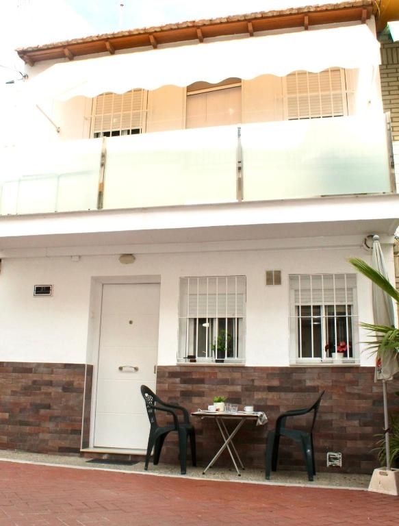 a table and chairs in front of a house at Casa Chica in Málaga