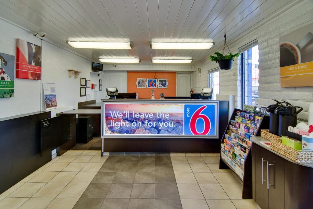 a large screen in a store with a sign on it at Motel 6-Eloy, AZ - Casa Grande in Eloy