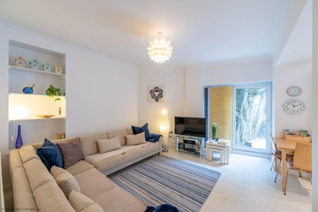 a living room with a couch and a table at Stones Throw in Woolacombe