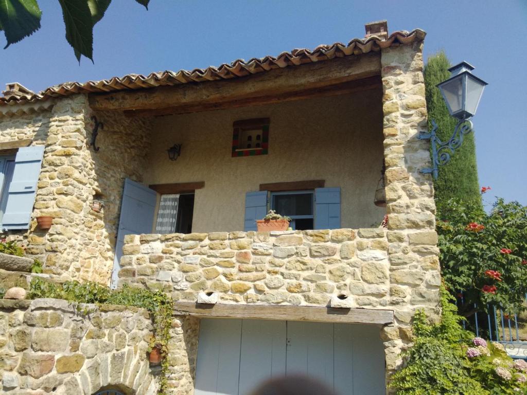 a stone house with a garage in front of it at La Grange in Cruis
