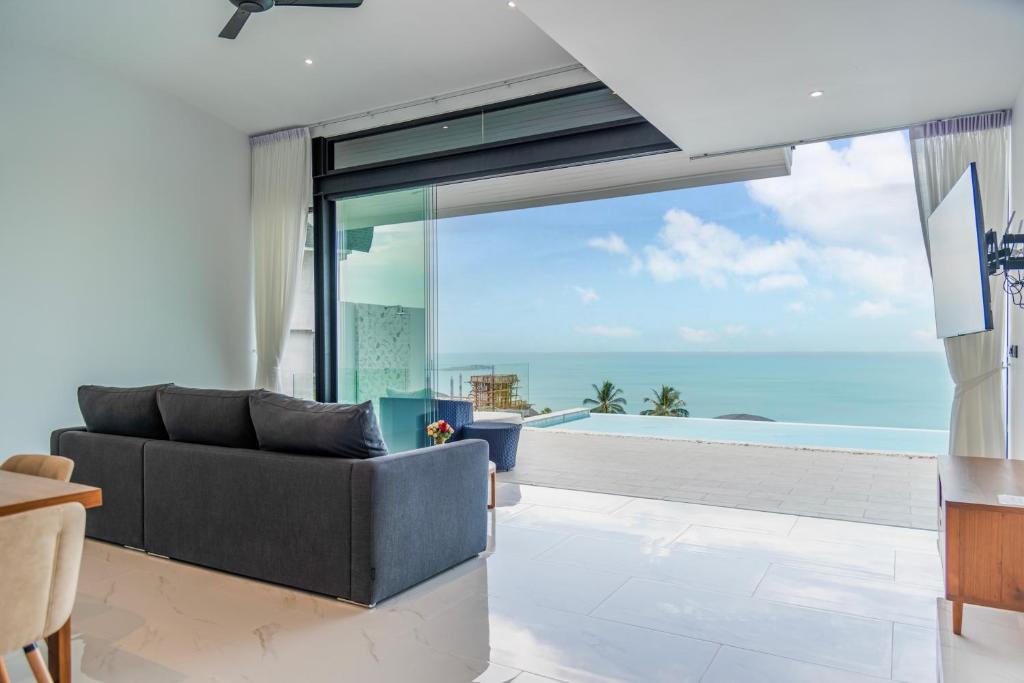 a living room with a couch and a view of the ocean at Sea View Chaweng Noi Villa Luxury in Chaweng Noi Beach