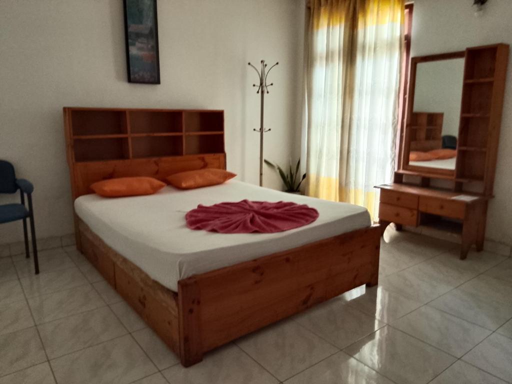 a bedroom with a large bed with a large mirror at Urenium Matara in Matara