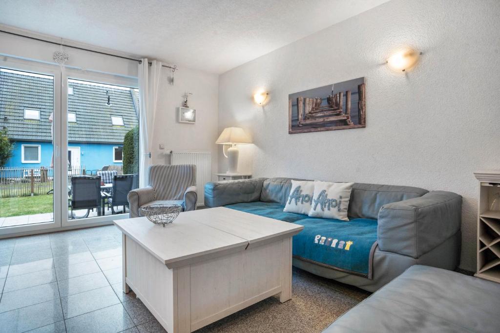 a living room with a couch and a table at Ostsee in Pruchten