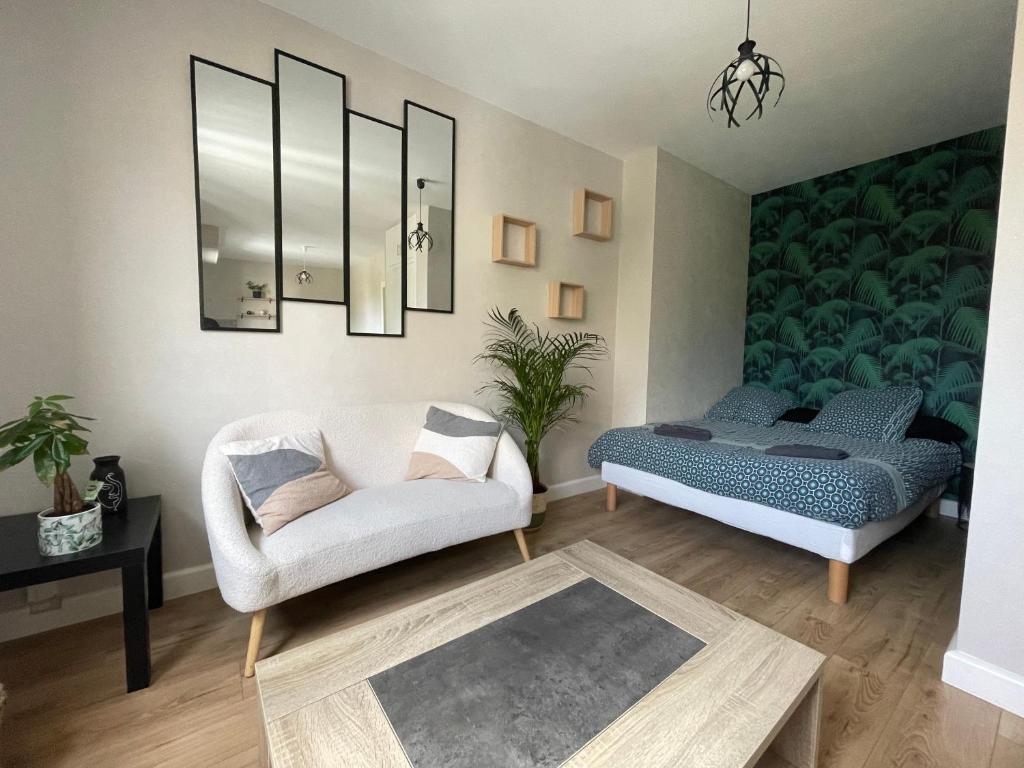 ein Wohnzimmer mit einem Bett und einer Couch in der Unterkunft Le P’tit B - Quartier Saint-Michel/Centre Ville in Saint-Brieuc