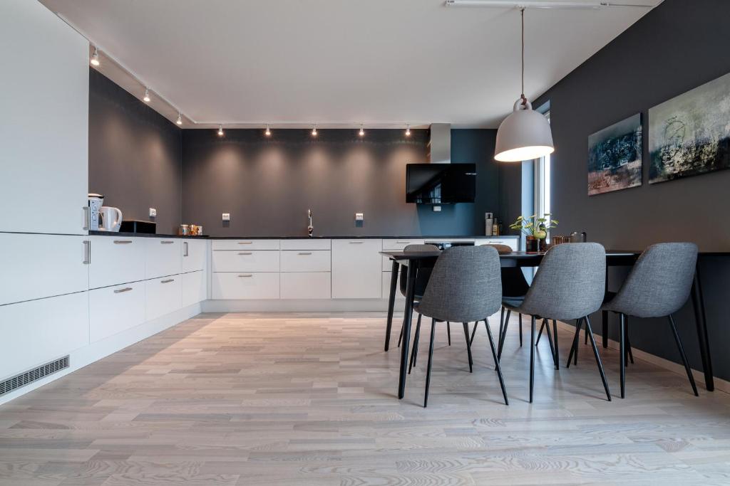 a kitchen with a dining room table and chairs at Seaside Apartment in Lofoten - Sea Views in Ballstad