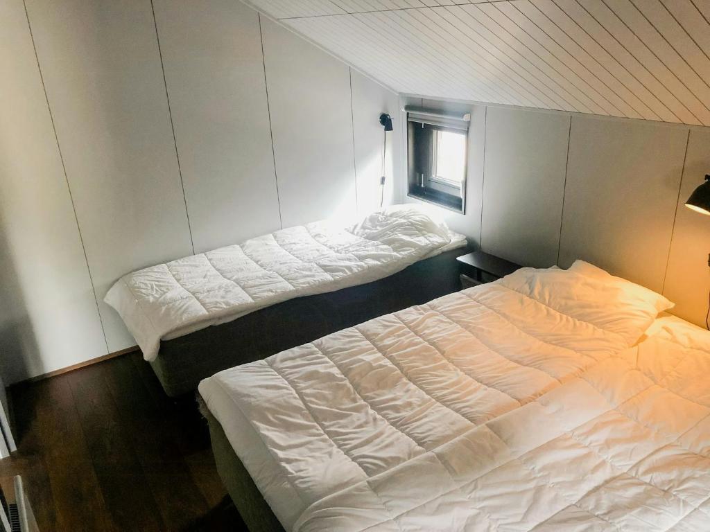 a bedroom with two beds and a window at Cabin In Stöten With Stunning Natural Surroundings in Stöten