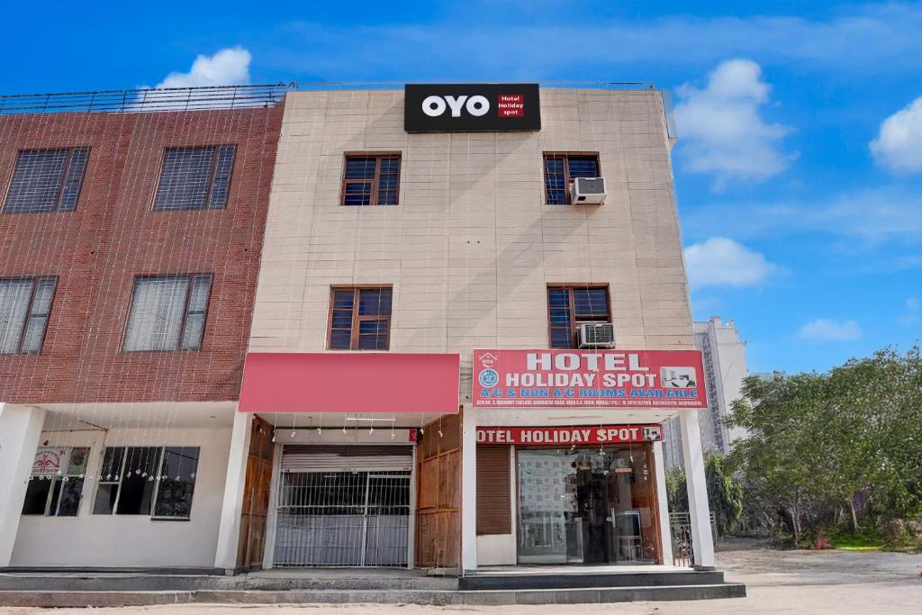 a building with a hoteluation sign in front of it at Super Hotel O ISBT Mohali Formerly Holiday Spot in Mohali