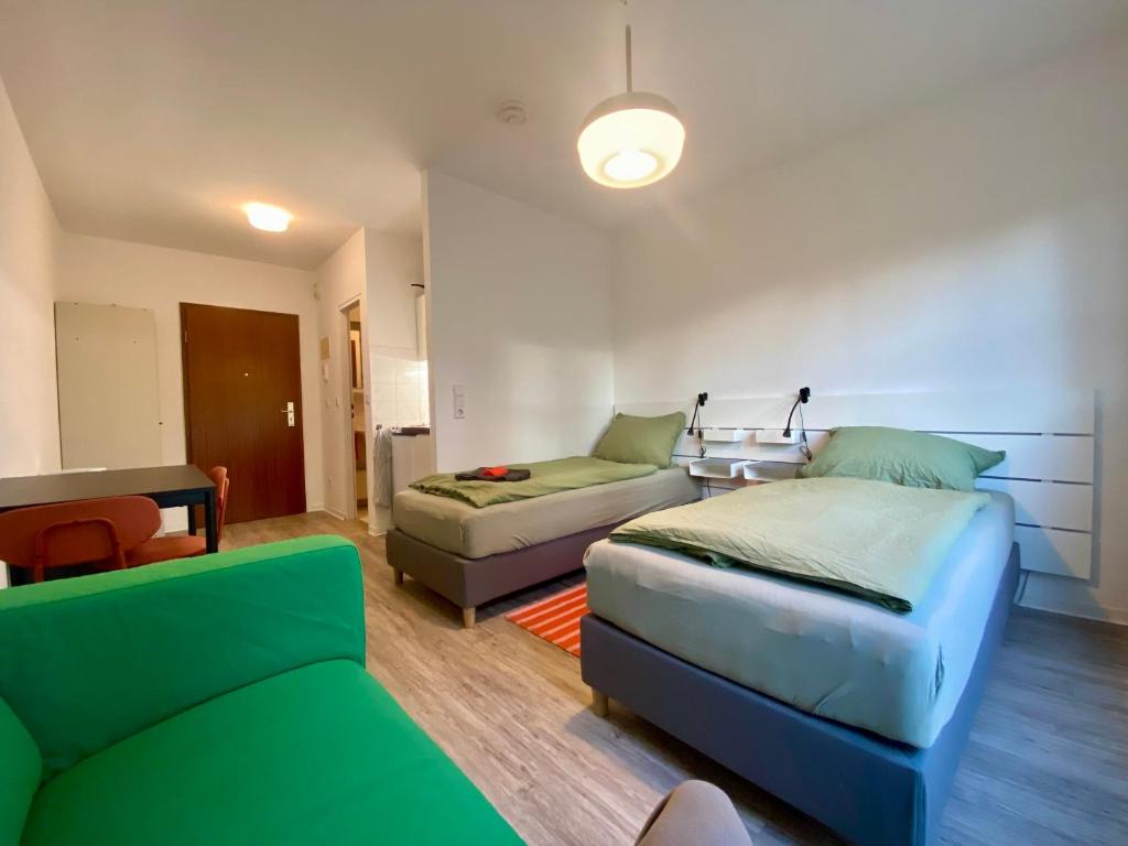 a living room with a bed and a couch at Work&Travel WE13 - Parkplatz, Netflix, Internet für 2 Gäste in Markranstädt