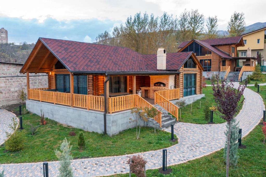 a home with a large deck and a house at Karpet Dilijan in Dilijan
