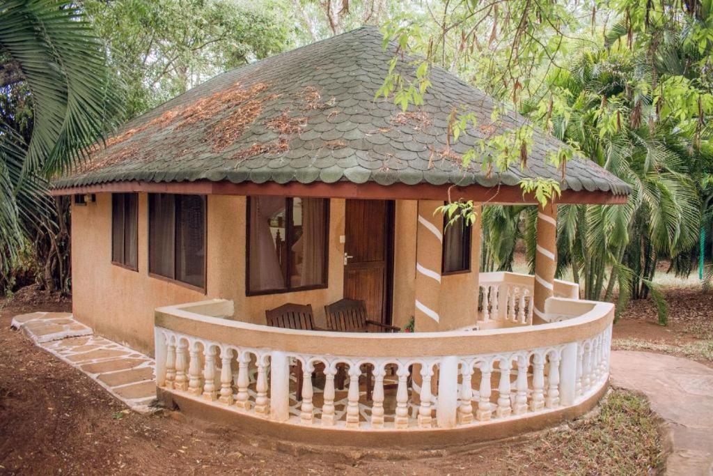 a small house with a porch and a roof at Lennana Escape in Ukunda
