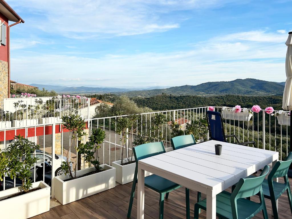 a white table and chairs on a balcony with a view at homeliday ACTIVE in Caldana