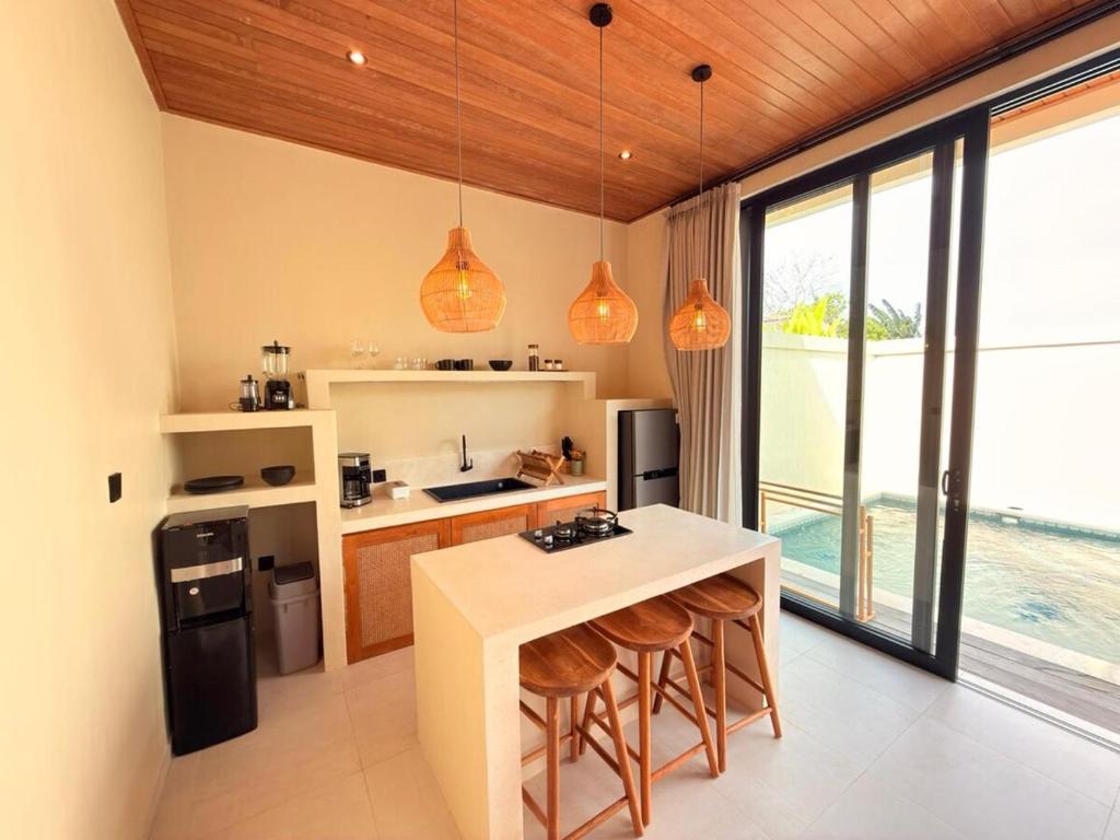 a kitchen with a island with a counter top at Villa Saraswati I in Uluwatu