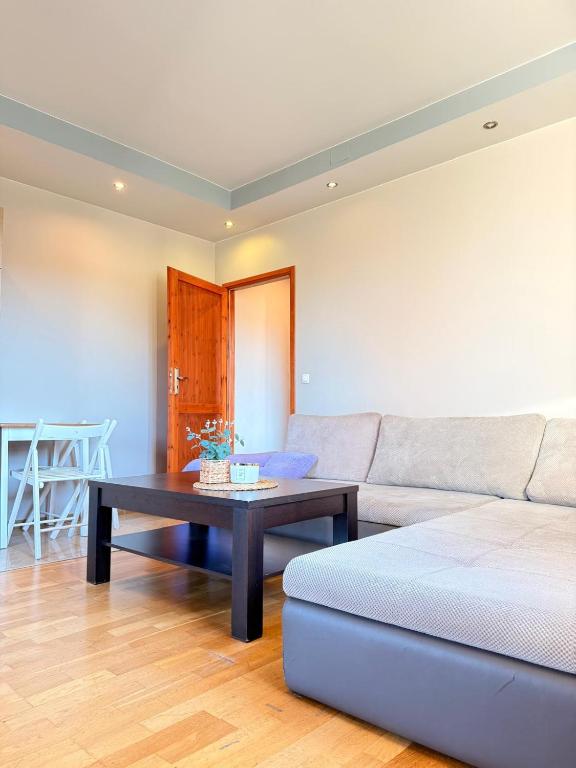 a living room with a couch and a coffee table at Apartamenty Gliwicka 12 