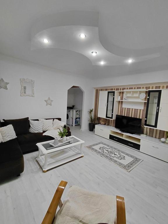 a living room with a couch and a table at La Monica - Straja - Lupeni - Retezat - Parang in Lupeni