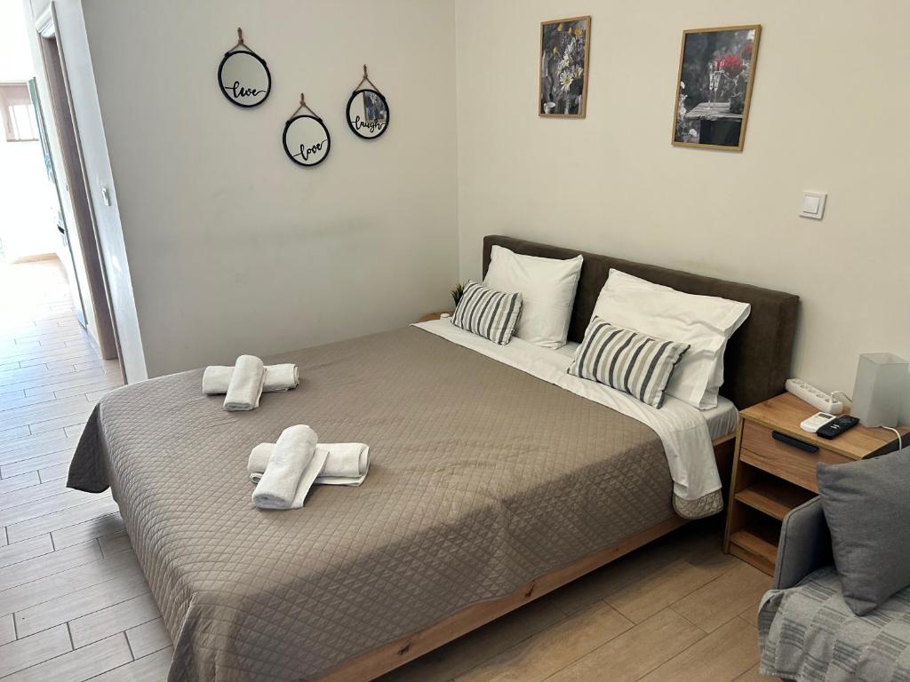 a bedroom with a bed with towels on it at Chris3 in Kalamata