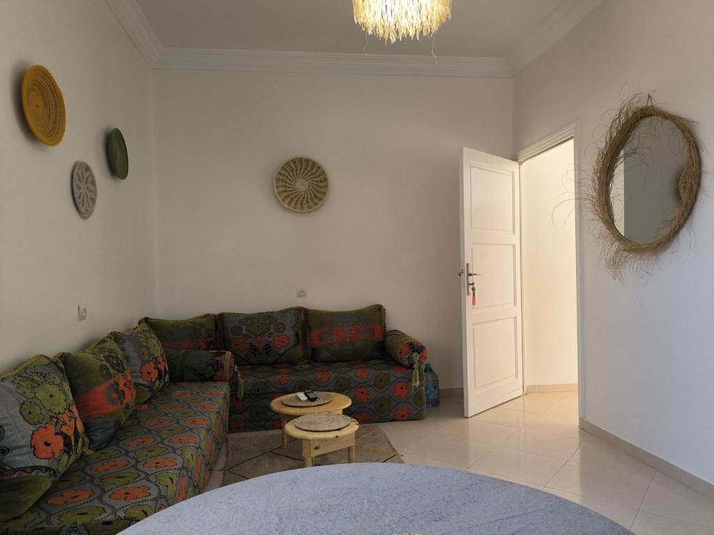 a living room with a couch and a table at Kaouki beachside apartment - 2 people in Essaouira