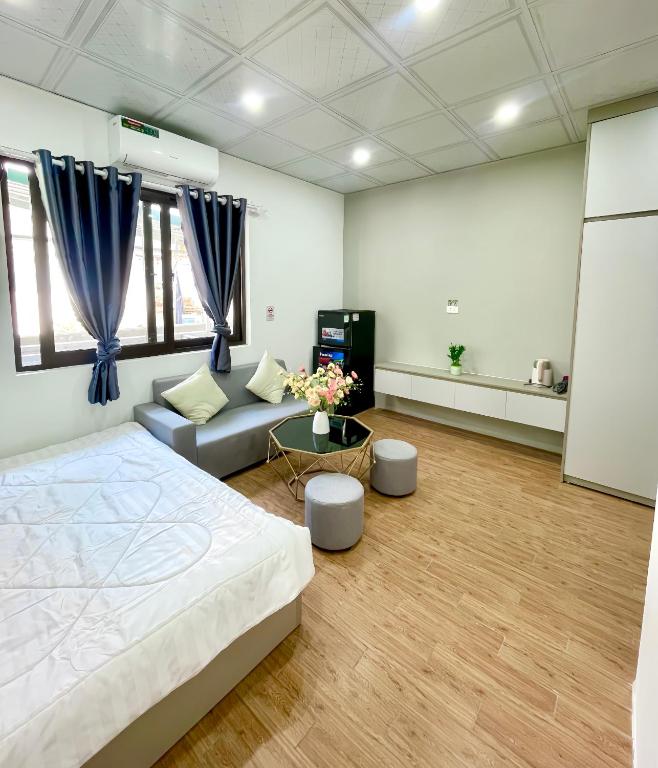 a large room with a bed and a couch at Hotel Diamond in Hanoi