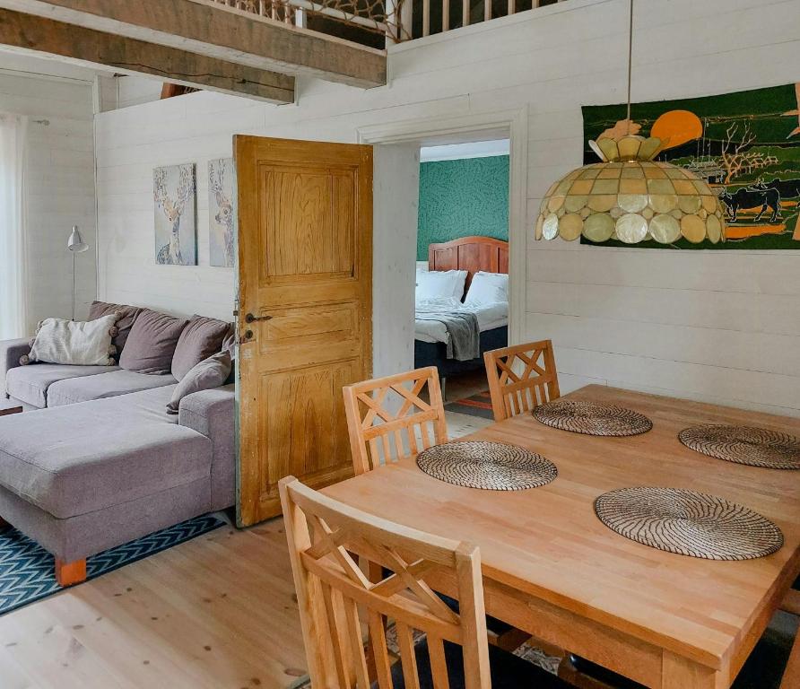 a living room with a table and a couch at Magical Barn Near The Sea in Ytterby
