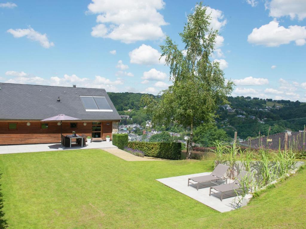 a yard with two chairs and a house at Luxury Apartment in Malmedy with bubble bath in Malmedy