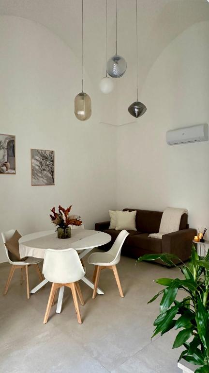 a living room with a table and chairs and a couch at Nina Mia in Fasano