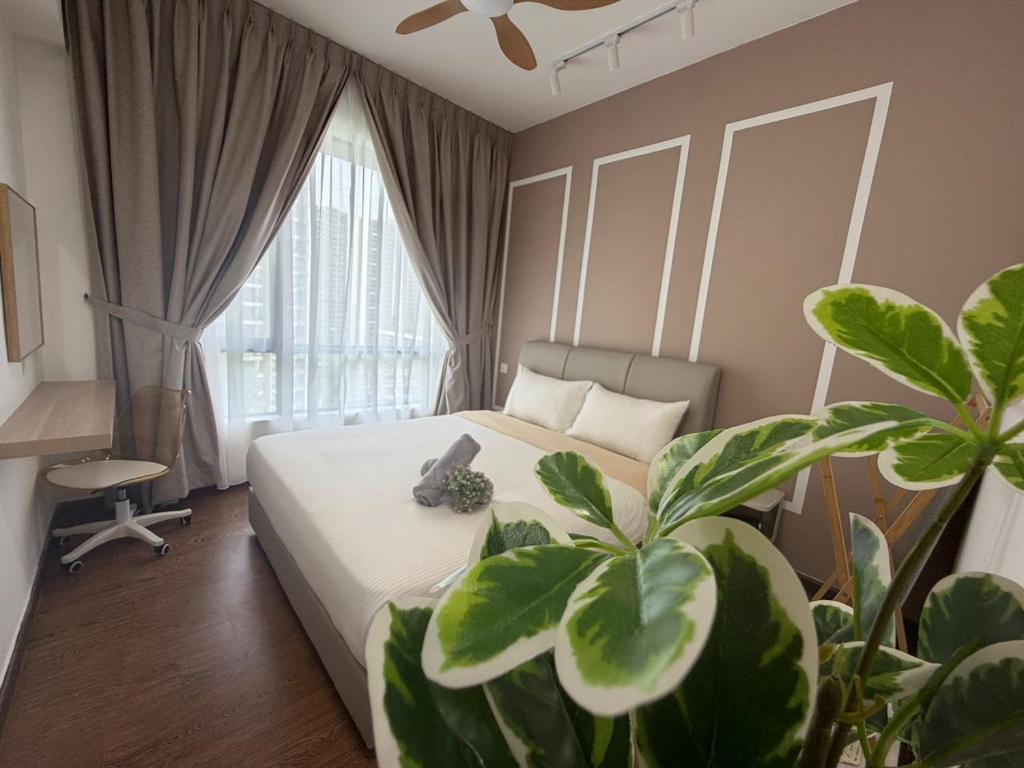 a bedroom with a bed and a potted plant at Central Park 2 Bedrooms in Johor Bahru