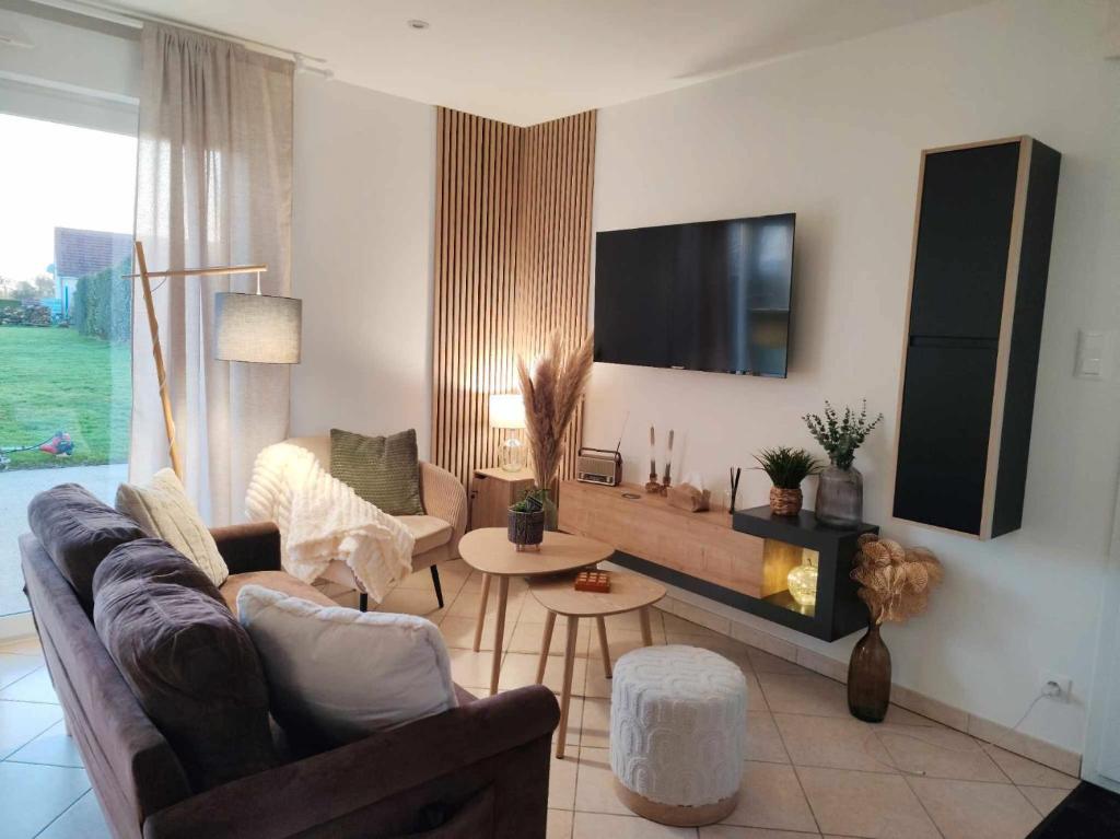a living room with a couch and a fire place at Gîte De L 'entre 2 Côtes in Vindefontaine