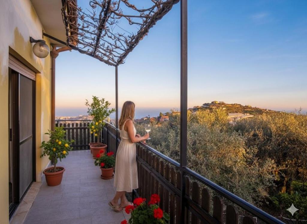 a woman standing on a balcony looking at the view at Da Ernestina in Imperia