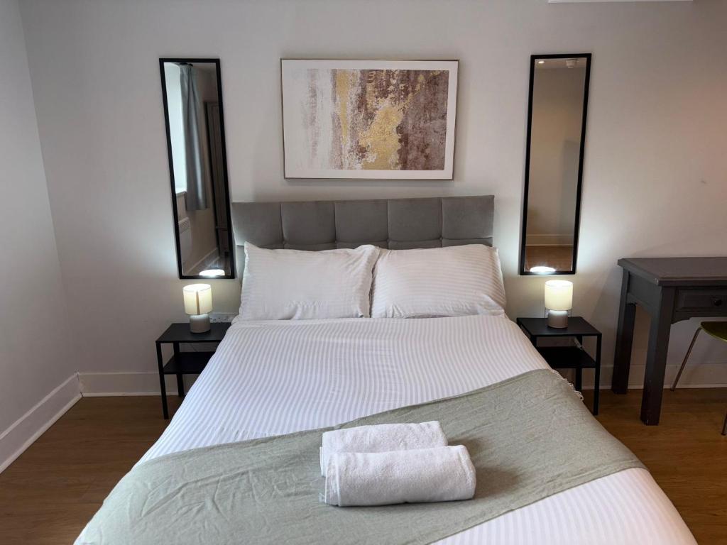 a bedroom with a large white bed with two tables at Newcastle Executive Stays in Newcastle upon Tyne