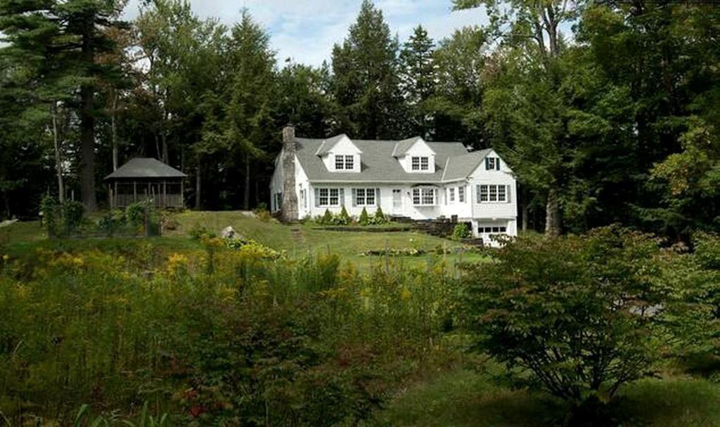 a large white house in a field with trees at Unique Ski Rental in Berkshires Charlemont Near Hawley State Forest, Plainfield, Western Massachusetts in Plainfield