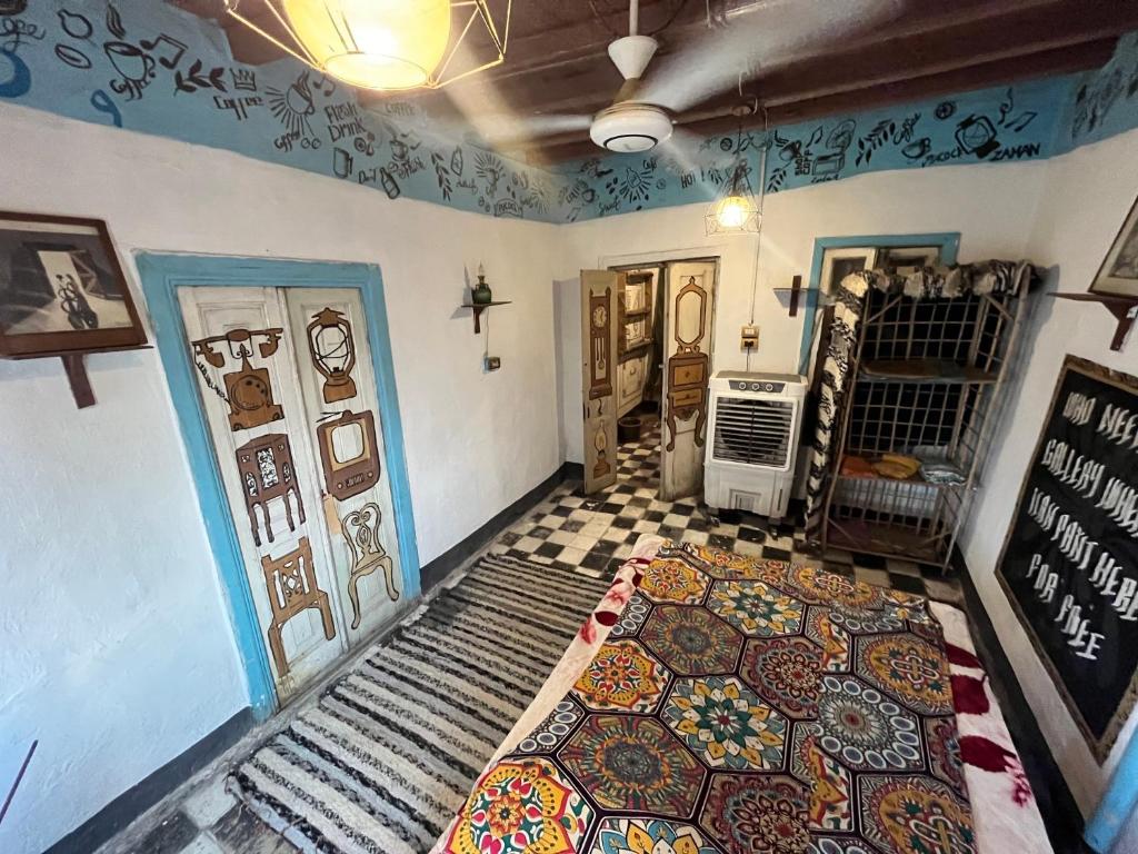 a room with a rug on the floor and two doors at Peacock guest house in Aswan