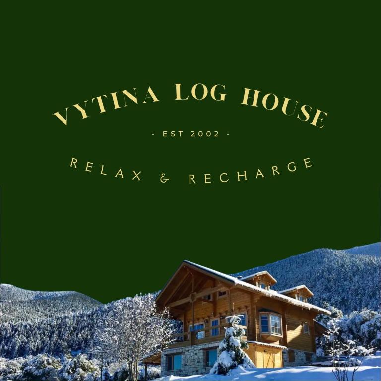 a sign for a winka log house in the snow at Vytina log house in Vitina