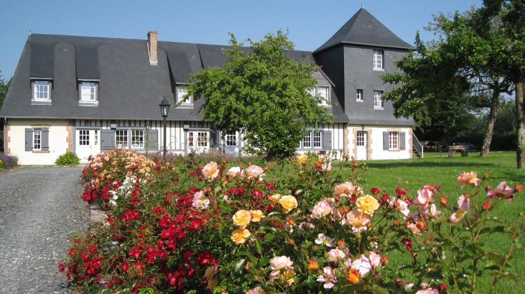 a house with a bunch of flowers in front of it at Manoir du Petit Saint-Pierre in Côte de Grâce