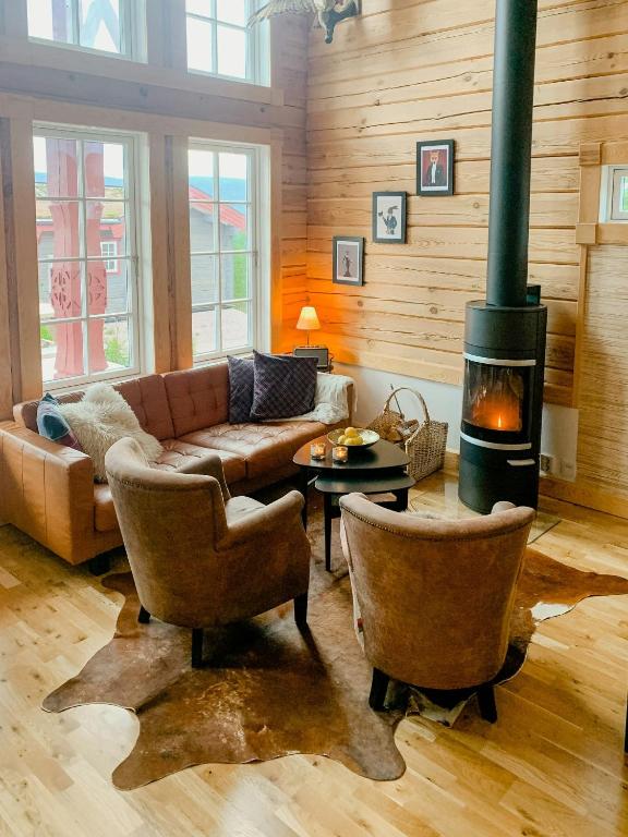 a living room with a couch and a fireplace at Mountain-Close Cabin With Panoramic View in Sälen
