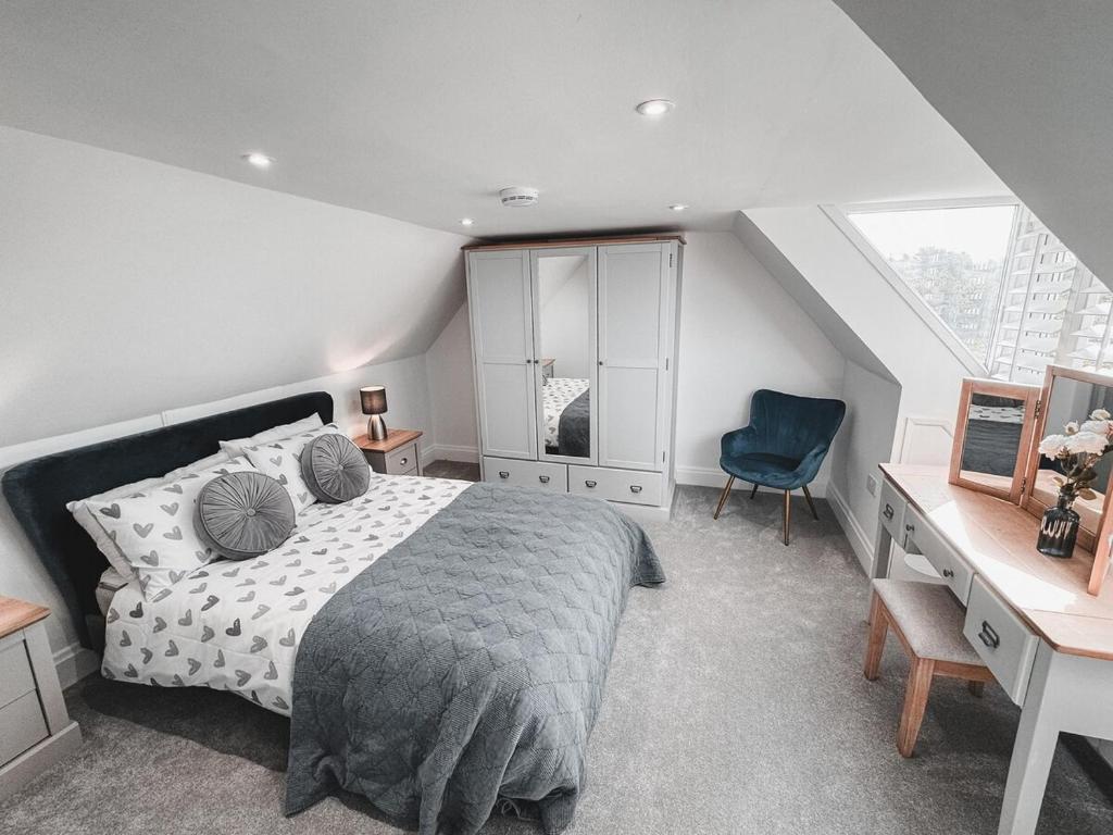 a bedroom with a bed and a desk and a chair at Charming 2-Bed House by Brookland Stays in Jersey Free Wi-Fi & Parking Included 