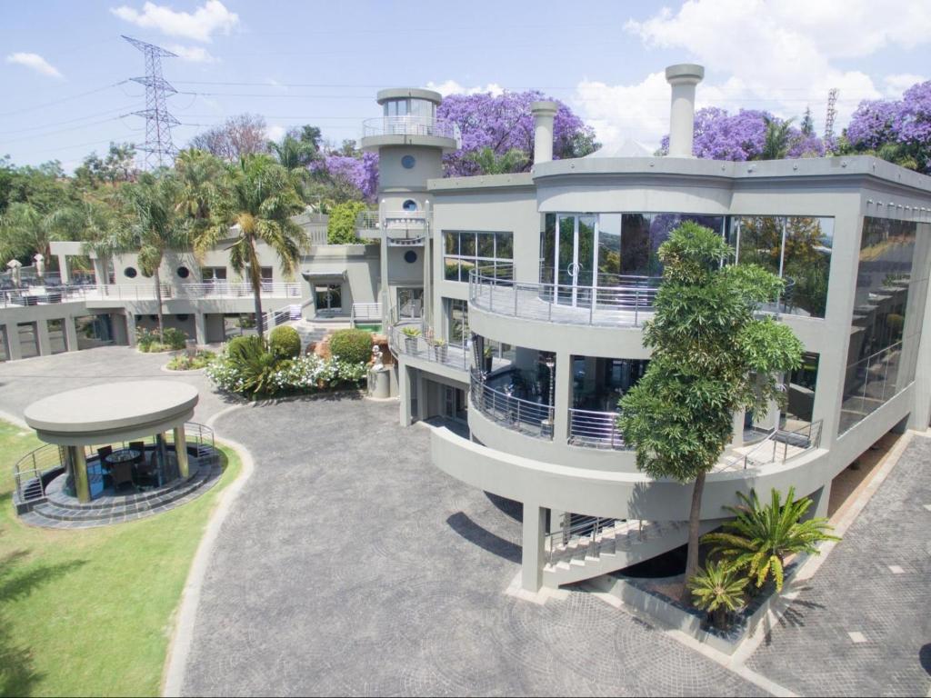 a large white building with a table in front of it at Silva Villa in Bedfordview
