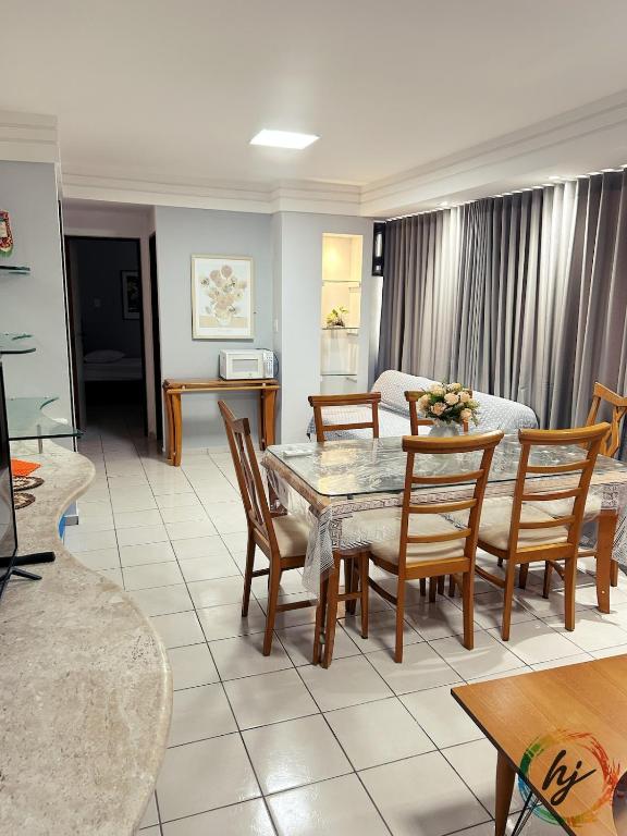 a living room with a table and chairs at Ponta de Pedra 103 in Ilha da Restinga