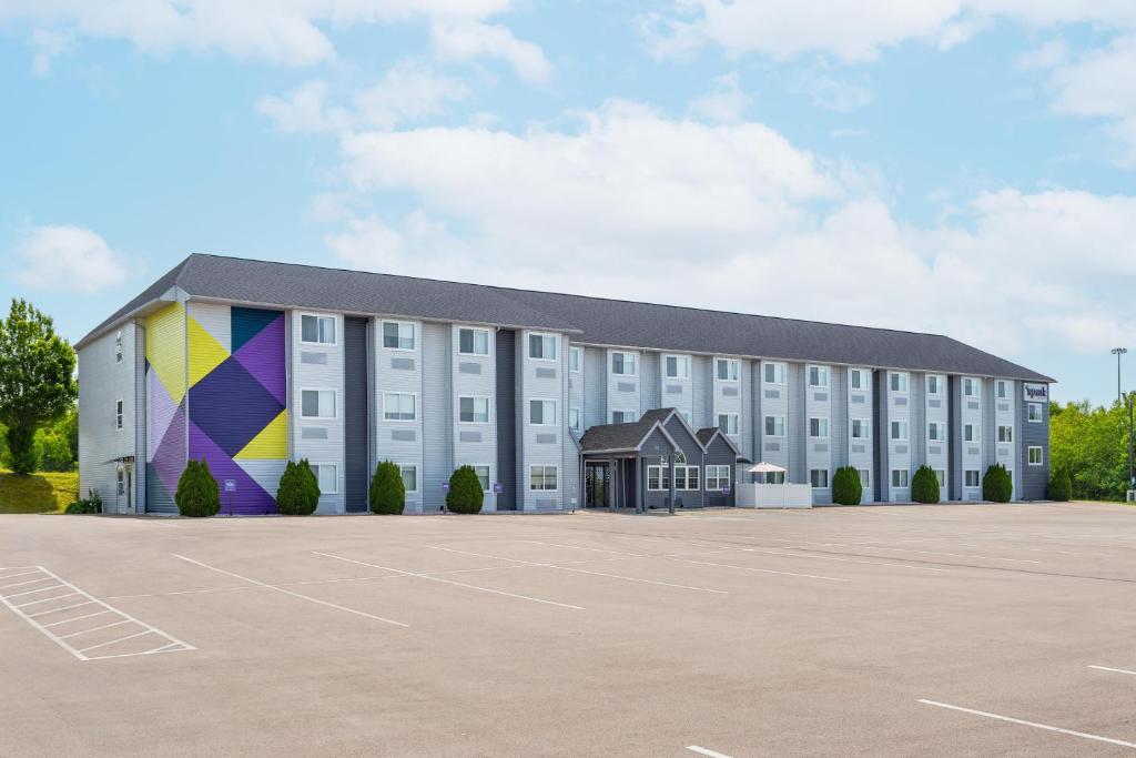 a large white building with a large parking lot at Spark by Hilton Clarion in Clarion