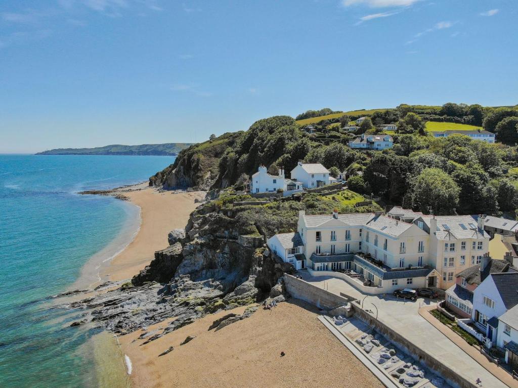 an aerial view of a house on a cliff next to the ocean at 9 At The Beach, Torcross in Torcross